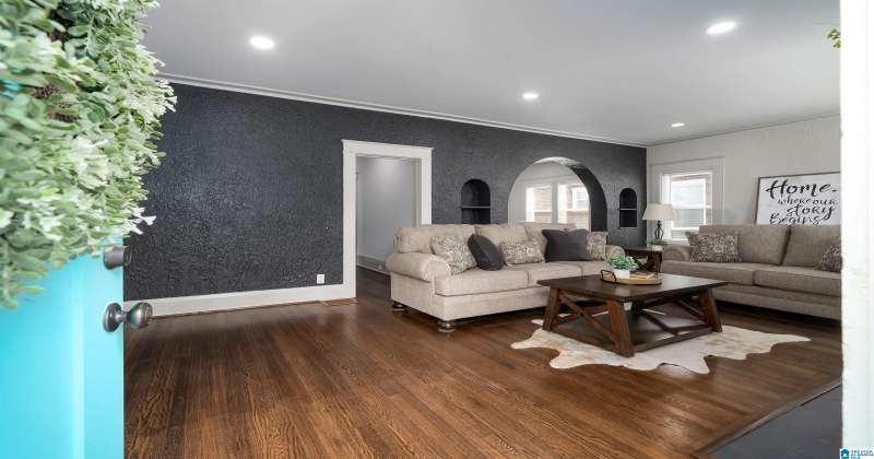 Huge living room with gleaming real hardwood flooring.