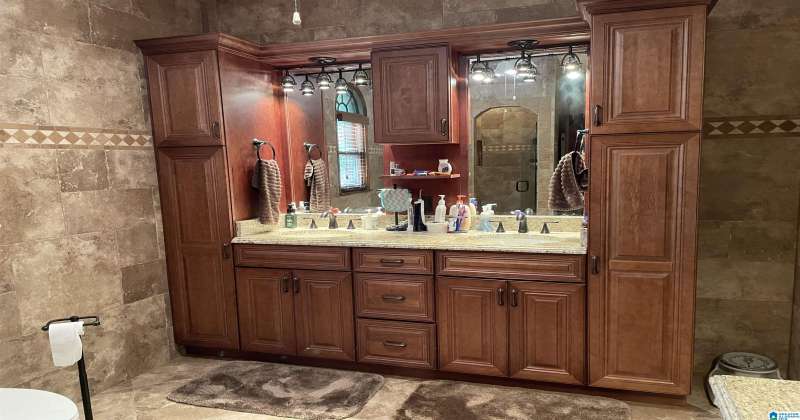 CUSTOM BUILT CABINETS WITH DOUBLE SINKS AND PLENTY OF STORAGE
